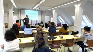 View from the auditorium towards participating students and the course leader